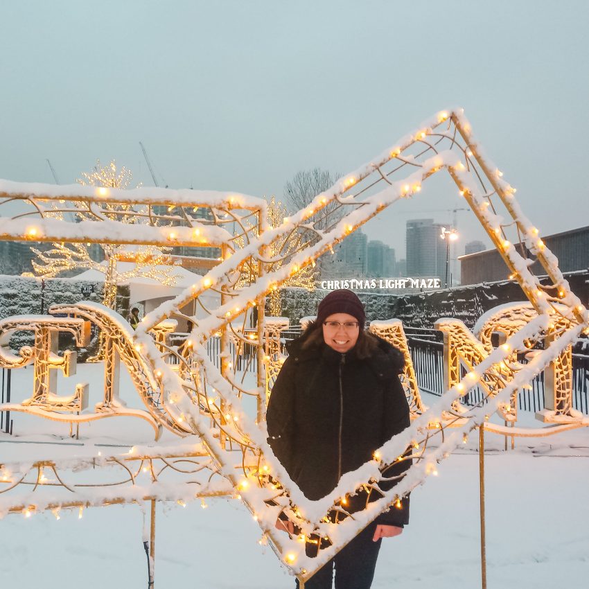 Standing in the snow at Enchant Christmas in Vancouver, Canada
