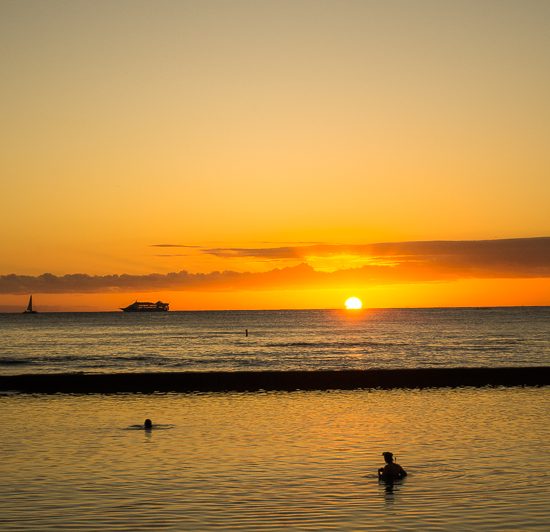 Sunsets over Waikiki Beach in Honolulu, Oahu, Hawaii, one of the best solo travel destinations in the United States.