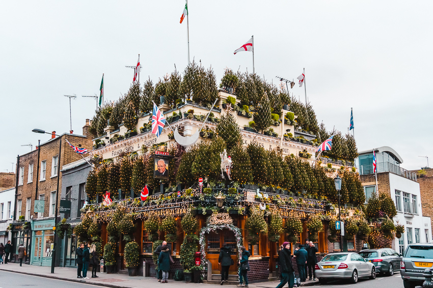The Churchill Arms pub decorated with Christmas trees in London, England