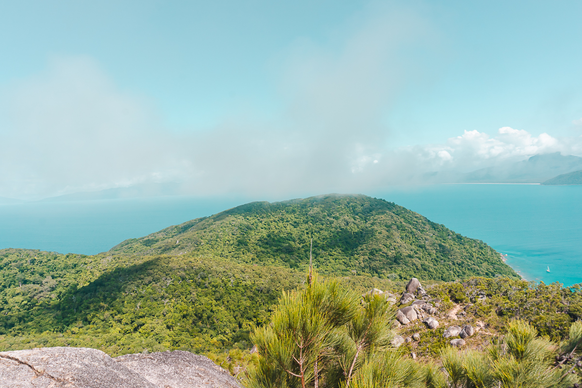 View of green hills and blue ocean from Summit Lookout on Fitzroy Island.