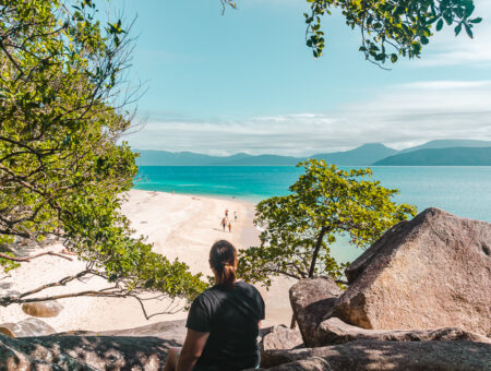 Hayley sitting on rock overlooking Nudey Beach on Fitzroy Island near Cairns.