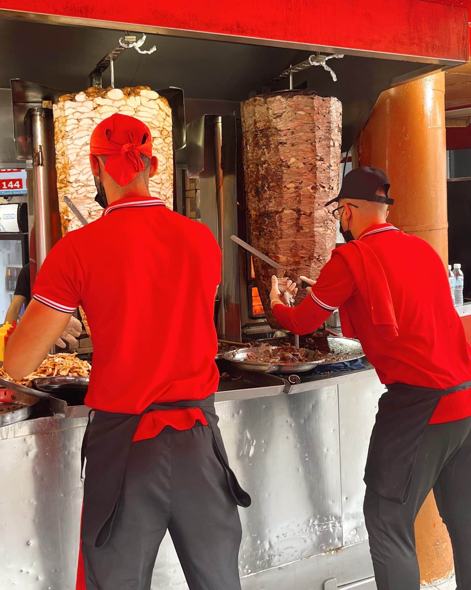 Workers cutting meat off spit grills at Damascus in Kuala Lumpur, Malaysia