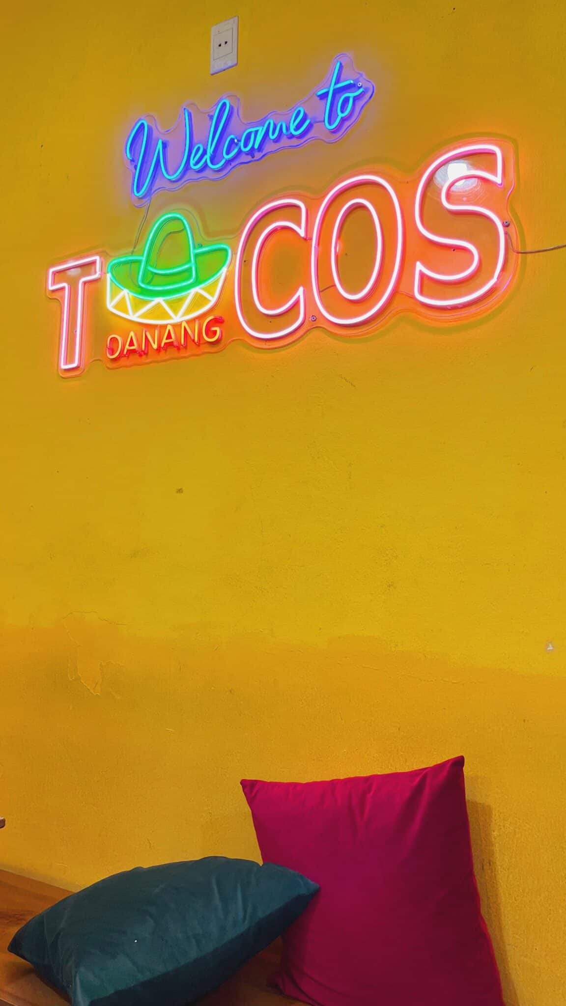 Bright yellow wall and sign at Tacos Danang in Da Nang, Vietnam