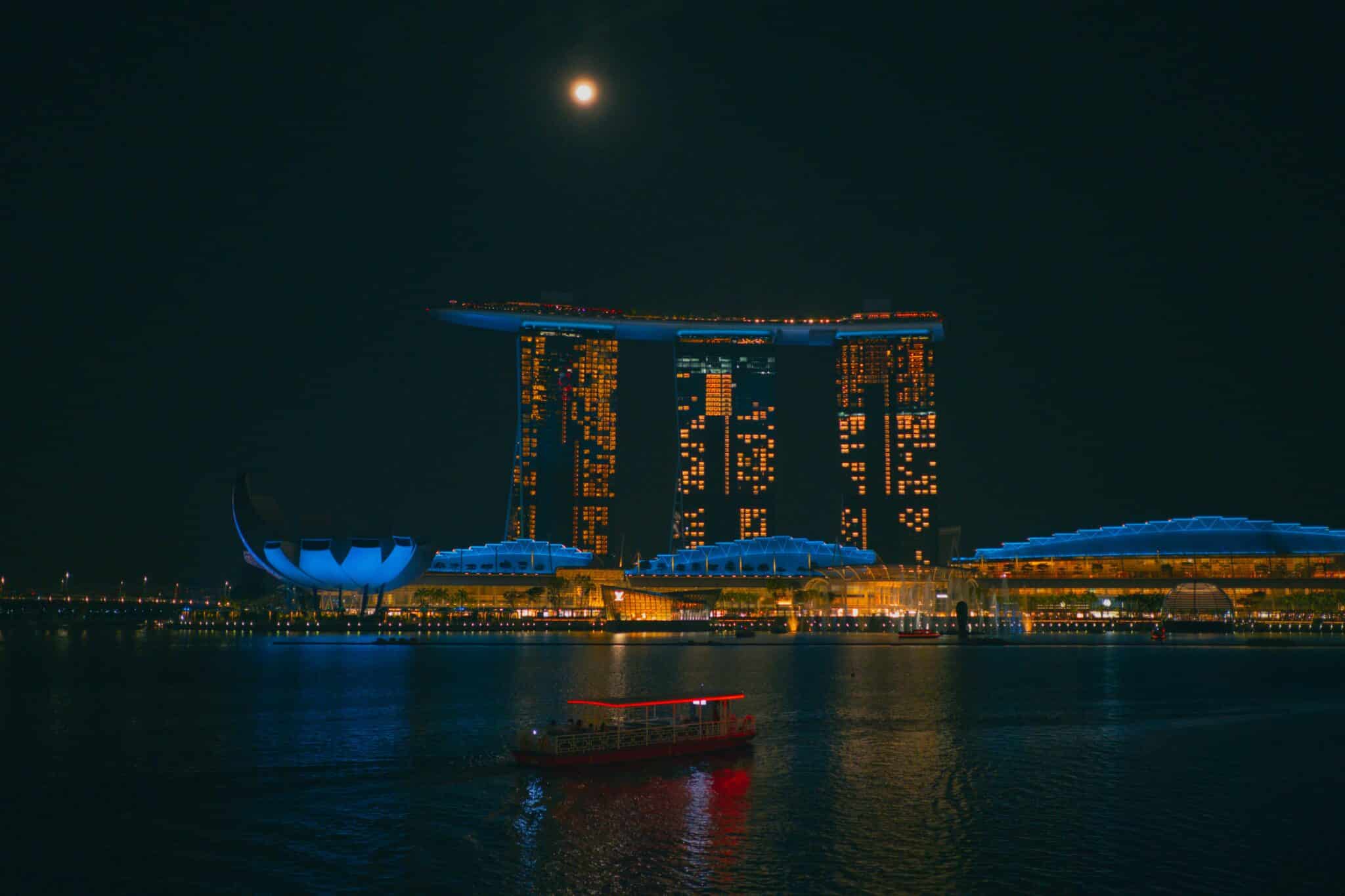 Boat on river in Singapore in front of Marina Bay Sands